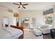 Bright main bedroom with seating area, outdoor access and dresser at 11255 S San Adrian Ln, Goodyear, AZ 85338