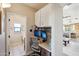 Convenient home office nook featuring a built-in desk, storage cabinets, and modern lighting at 11255 S San Adrian Ln, Goodyear, AZ 85338