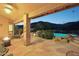 Covered patio features a fire pit and beautiful views of the pool at 11255 S San Adrian Ln, Goodyear, AZ 85338