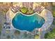 Aerial shot showing a kidney-shaped pool with a rock waterfall and desert landscaping at 11255 S San Adrian Ln, Goodyear, AZ 85338