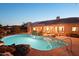 Backyard pool with lush landscaping and solar panels on roof, creating an eco-friendly retreat at 11255 S San Adrian Ln, Goodyear, AZ 85338