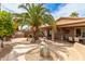 Extensive backyard featuring lush desert landscaping, dining, seating and an outdoor kitchen and bar at 1173 E Daisy Way, San Tan Valley, AZ 85143