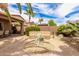 Beautiful backyard with desert landscaping, a built-in stone bench and a sitting area at 1173 E Daisy Way, San Tan Valley, AZ 85143