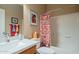 Cozy bathroom featuring a tub with colorful shower curtain and coordinated decor at 1173 E Daisy Way, San Tan Valley, AZ 85143