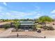 Lovely view of community clubhouse with golf carts, mature landscaping, and ample parking at 1173 E Daisy Way, San Tan Valley, AZ 85143