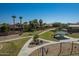 Neighborhood park featuring walking paths, benches, picnic shelter, playground, and lush landscaping at 1173 E Daisy Way, San Tan Valley, AZ 85143