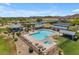 Aerial view of a sparkling community pool with lounge chairs and shaded seating areas at 1173 E Daisy Way, San Tan Valley, AZ 85143