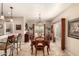 Formal dining room with a large wooden table, tiled floor, and sliding glass doors to the patio at 1173 E Daisy Way, San Tan Valley, AZ 85143