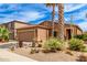 Charming single-Gathering home with desert landscaping, palm trees, and a two-car garage at 1173 E Daisy Way, San Tan Valley, AZ 85143