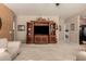 Spacious living room featuring carpeted flooring, a built-in entertainment center, and access to other rooms at 1173 E Daisy Way, San Tan Valley, AZ 85143