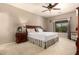 Spacious main bedroom featuring a ceiling fan, carpet flooring, and large window at 1173 E Daisy Way, San Tan Valley, AZ 85143