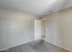 Empty bedroom showcasing neutral paint, carpet, and an open door at 12233 W Aster Dr, El Mirage, AZ 85335