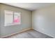 A sunlit bedroom with carpet and views of flowering plants outside the window at 12233 W Aster Dr, El Mirage, AZ 85335
