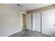 A carpeted bedroom with open and closed doors at 12233 W Aster Dr, El Mirage, AZ 85335