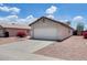 Home with a driveway and two-car garage complemented by lovely desert landscaping at 12233 W Aster Dr, El Mirage, AZ 85335