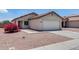 Home with a driveway and two-car garage complemented by lovely desert landscaping and an inviting entrance at 12233 W Aster Dr, El Mirage, AZ 85335