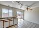 An open kitchen featuring standard appliances, a window overlooking the backyard, and ample counter space at 12233 W Aster Dr, El Mirage, AZ 85335