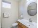 Bathroom featuring single sink vanity, mirror, and a toilet at 1335 E June St # 107, Mesa, AZ 85203