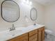 Bathroom featuring double sink vanity, mirrors, and a toilet at 1335 E June St # 107, Mesa, AZ 85203