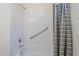 Clean bathtub with showerhead, safety bar, and chevron shower curtain at 1335 E June St # 107, Mesa, AZ 85203