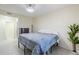 Simple bedroom with bed, dresser, and view of entrance to ensuite bathroom at 1335 E June St # 107, Mesa, AZ 85203