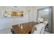 Dining area with wood table and chairs, stylish mirror, and a view into the kitchen at 1335 E June St # 107, Mesa, AZ 85203