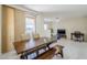 Dining area with a wooden table, bench, neutral walls, and access to an outdoor patio at 1335 E June St # 107, Mesa, AZ 85203