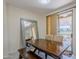 Bright dining room showcasing a wooden table, bench seating, and a large stylish mirror at 1335 E June St # 107, Mesa, AZ 85203