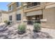 Condominium exterior featuring desert landscaping and a private patio with sliding glass doors at 1335 E June St # 107, Mesa, AZ 85203