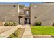 Inviting exterior view of a multi-level townhome with manicured landscaping and walkway at 1335 E June St # 107, Mesa, AZ 85203