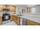 Well-lit kitchen featuring stainless steel appliances, ample counter space, and wooden cabinets at 1335 E June St # 107, Mesa, AZ 85203