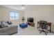 Comfortable living area with modern furniture, media console, and lots of natural light at 1335 E June St # 107, Mesa, AZ 85203
