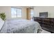 Bright bedroom with bed, dresser, and a view of the community at 1335 E June St # 107, Mesa, AZ 85203