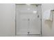 Shower featuring glass door, white tiles, and stainless steel fixtures at 1335 E June St # 107, Mesa, AZ 85203
