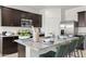 Spacious kitchen with dark cabinets, granite countertops, stainless steel appliances, and island seating at 1342 W Hess Ave, Coolidge, AZ 85128