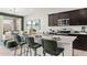 Bright kitchen featuring stainless steel appliances, dark wood cabinets and seating at the island at 1342 W Hess Ave, Coolidge, AZ 85128