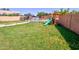 Large backyard featuring a swing set and a glimpse of the refreshing pool area, perfect for outdoor enjoyment at 1556 E Gabrilla Dr, Casa Grande, AZ 85122