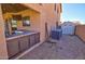 Low angle view of a backyard featuring an outdoor kitchen and air conditioning units at 1556 E Gabrilla Dr, Casa Grande, AZ 85122