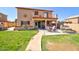 Expansive backyard features a well-manicured lawn, patio, and path leading to lush landscaping at 1556 E Gabrilla Dr, Casa Grande, AZ 85122