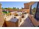 Outdoor kitchen with granite countertops and a sink, perfect for outdoor entertaining at 1556 E Gabrilla Dr, Casa Grande, AZ 85122