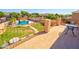 Second story view of a large backyard with a pool, grassy area and mature landscaping at 1556 E Gabrilla Dr, Casa Grande, AZ 85122