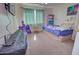 This cozy bedroom has a ceiling fan and a large window for natural lighting at 1556 E Gabrilla Dr, Casa Grande, AZ 85122
