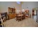Spacious dining room with high ceilings, tile floors, and large wooden table and display cabinet at 1556 E Gabrilla Dr, Casa Grande, AZ 85122