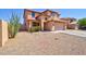 Two-story home featuring a spacious driveway with desert landscaping including a cactus and other greenery at 1556 E Gabrilla Dr, Casa Grande, AZ 85122