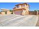 Two-story home with a large driveway featuring a two car garage and privacy gate at 1556 E Gabrilla Dr, Casa Grande, AZ 85122
