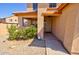 View of front porch, showing a sunburst decoration, a welcome mat, and various decorative plants at 1556 E Gabrilla Dr, Casa Grande, AZ 85122