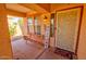 Inviting front porch featuring a bench, welcome sign, decorative plants and colorful mat at 1556 E Gabrilla Dr, Casa Grande, AZ 85122