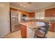 Kitchen featuring stainless steel appliances, breakfast bar, and tile backsplash at 1556 E Gabrilla Dr, Casa Grande, AZ 85122