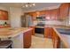 Kitchen with stainless steel appliances, breakfast bar, and wooden cabinets at 1556 E Gabrilla Dr, Casa Grande, AZ 85122