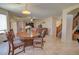 Bright living room featuring a round table, couch, tv, and tile floors, perfect for relaxed living at 1556 E Gabrilla Dr, Casa Grande, AZ 85122